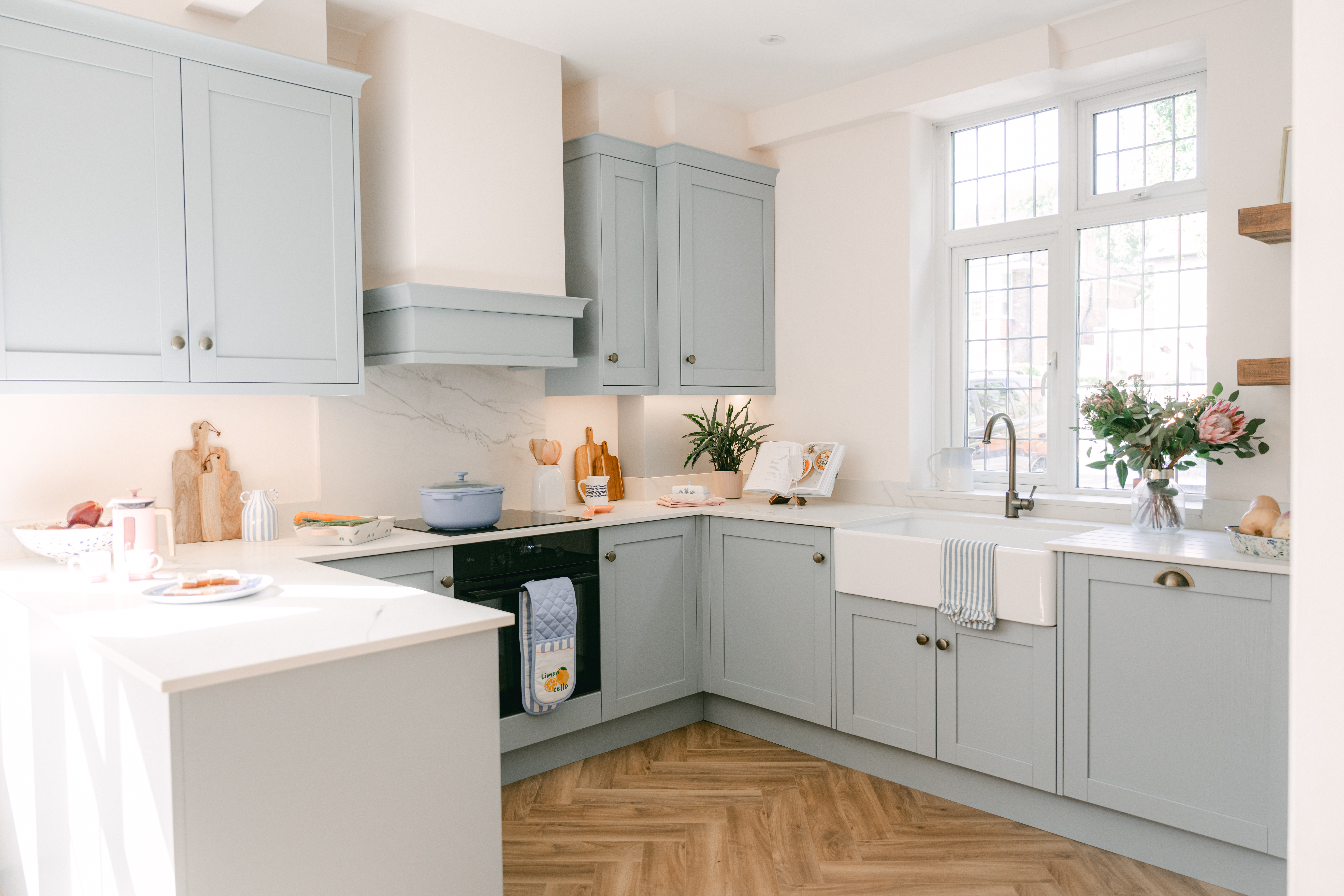 Duck egg blue shaker kitchen with cream range and stone worktops