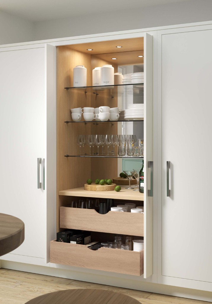 Tall pantry cabinetry with oak interior and pocket doors