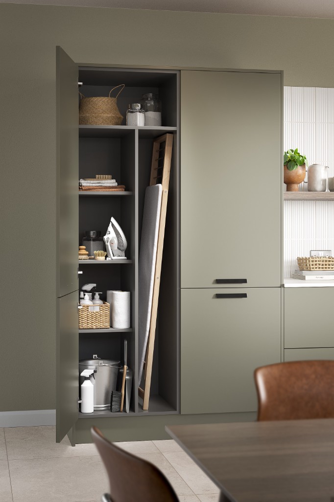 Sage green utility cabinetry with oak and charcoal interiors